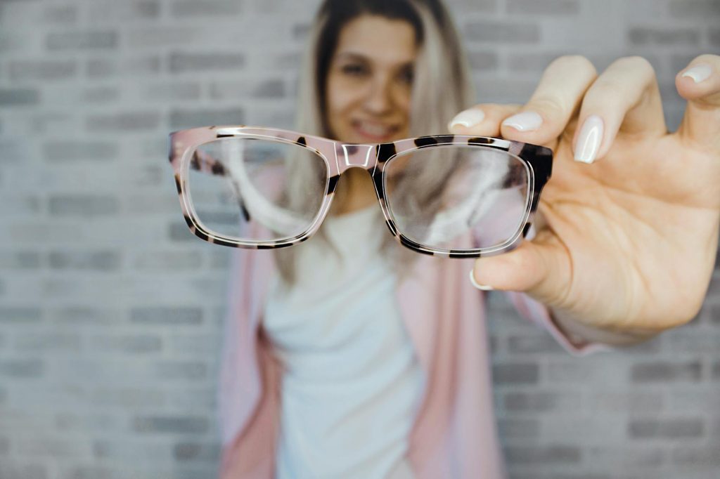 selective focus photography of pink and black framed eyeglasses